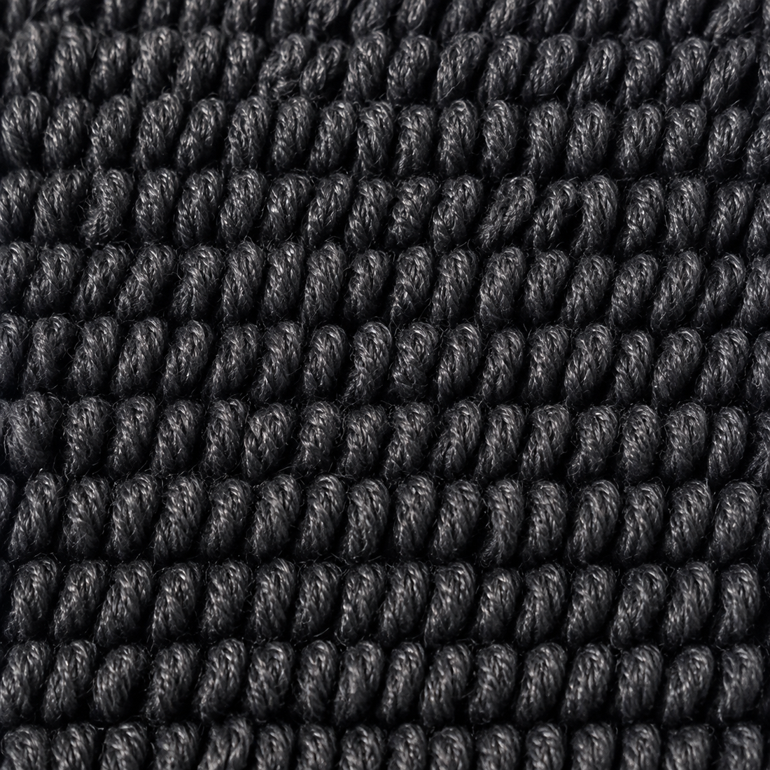 Macro du tissage twisted loop : boucles torsadées sur elles-mêmes, serrées et régulières